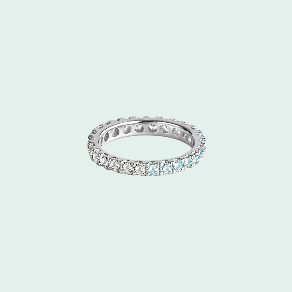 Silver ring with embedded diamonds on a white background