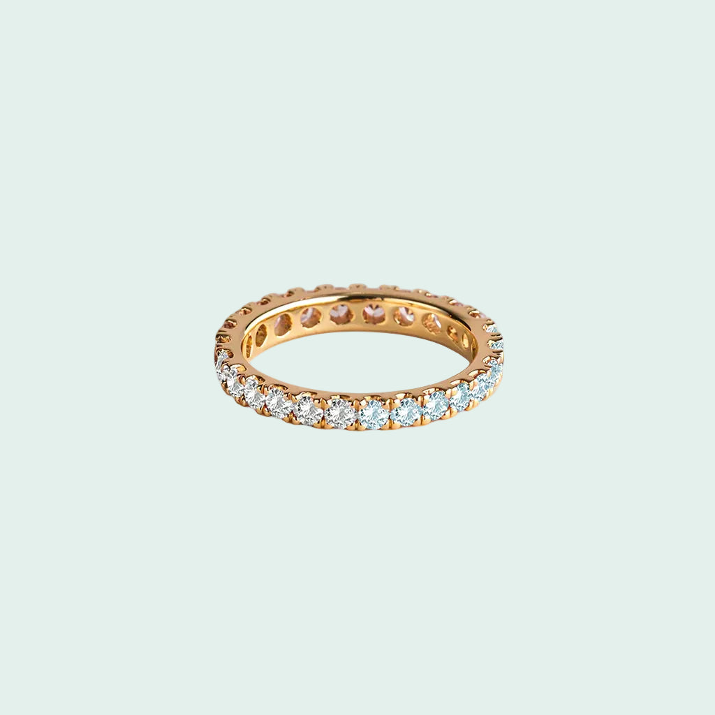 Gold ring with embedded diamonds on a white background