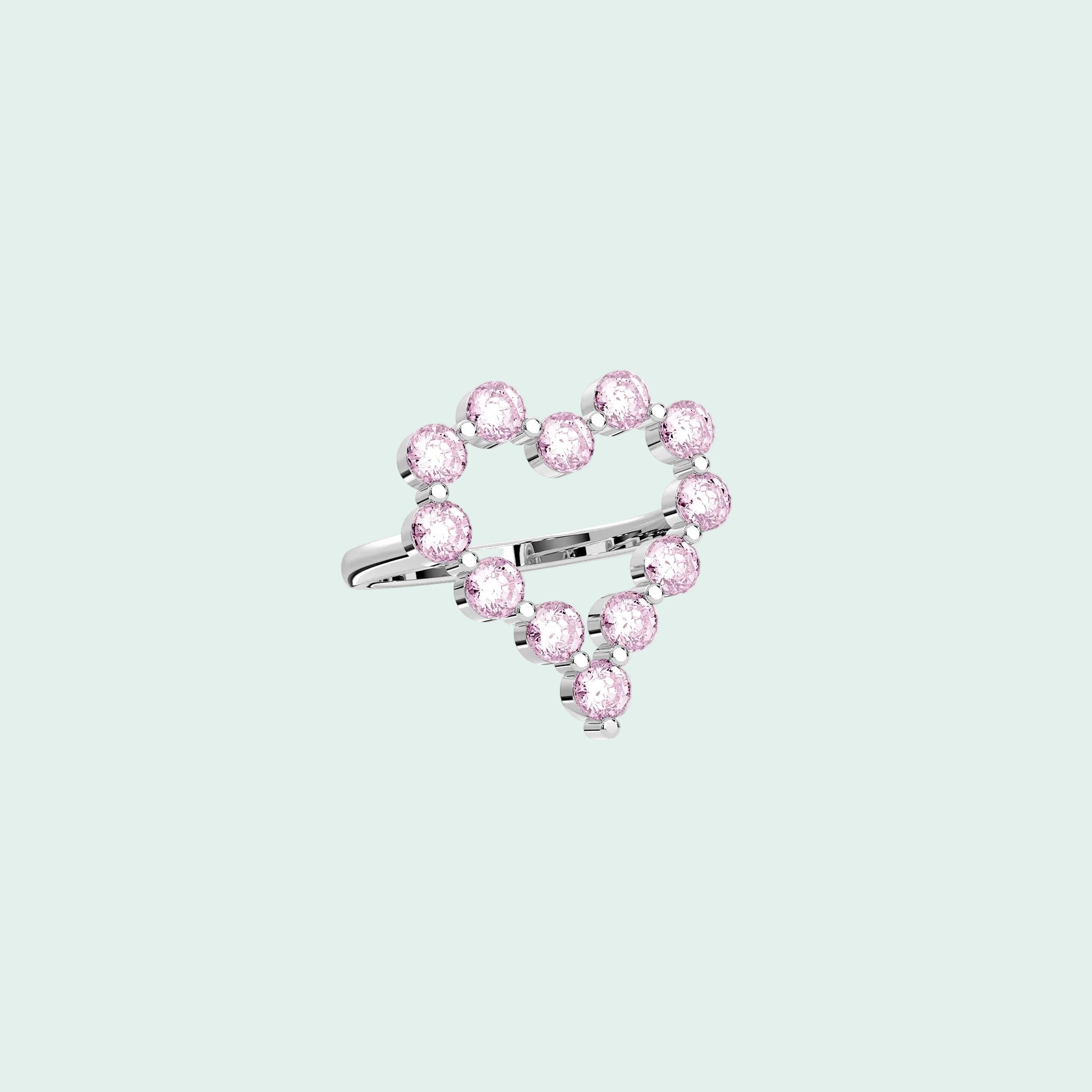 Heart-shaped ring with pink gemstones on a white background