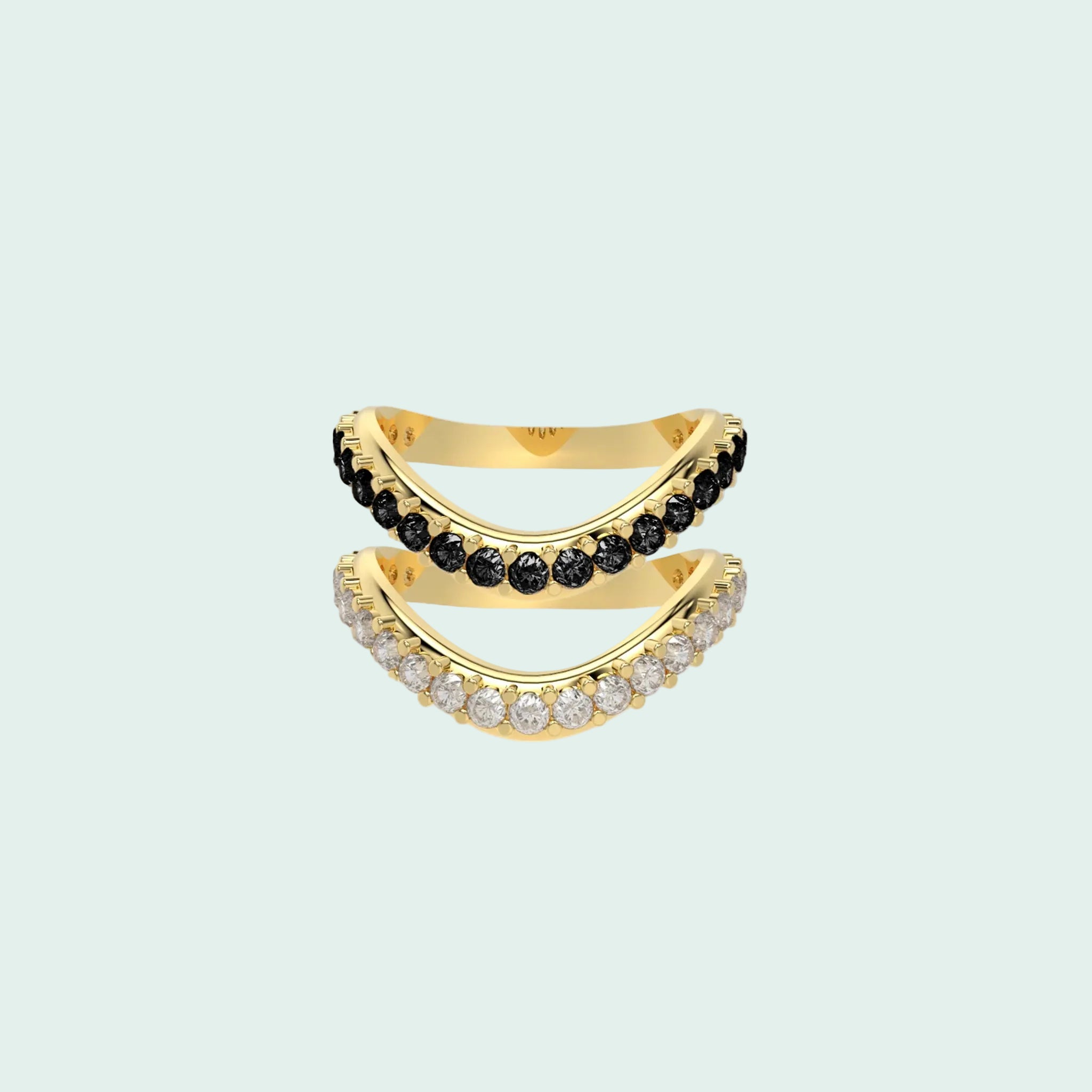 Gold ring with black and clear gemstones on a white background