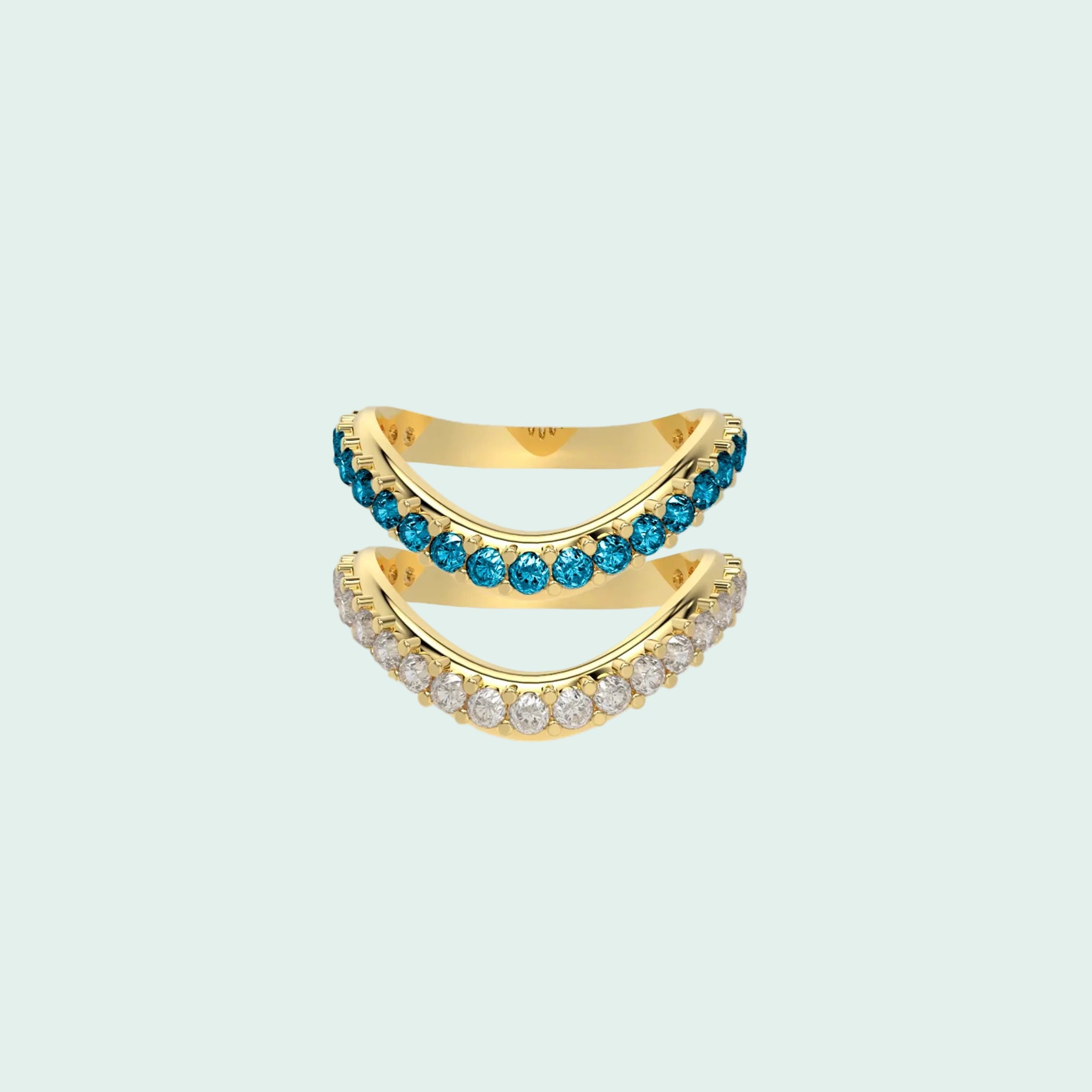 Gold ring with blue and clear gemstones on a white background