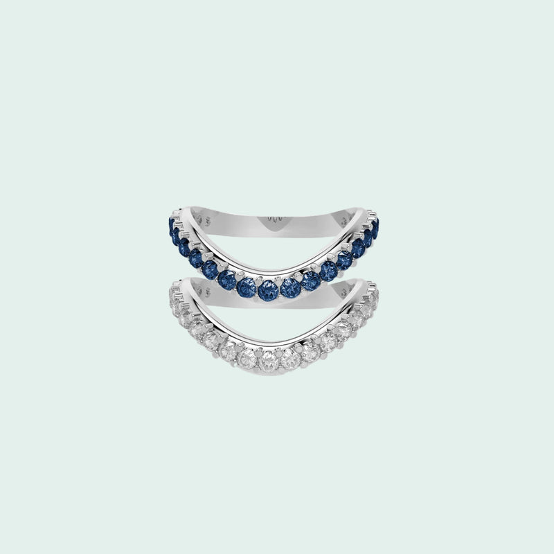 Silver ring with blue gemstones on a white background