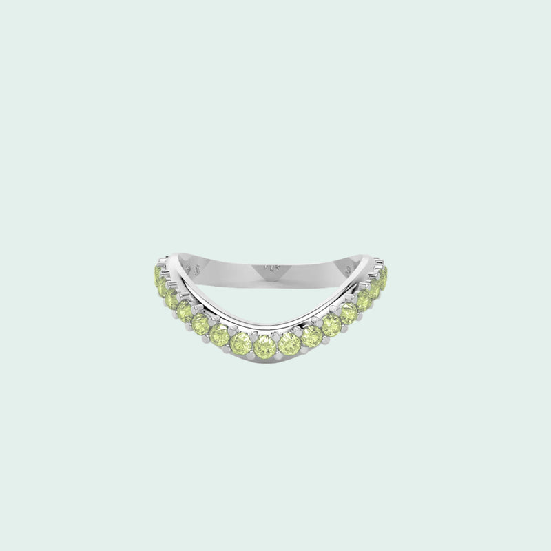 Silver ring with green gemstones on a white background