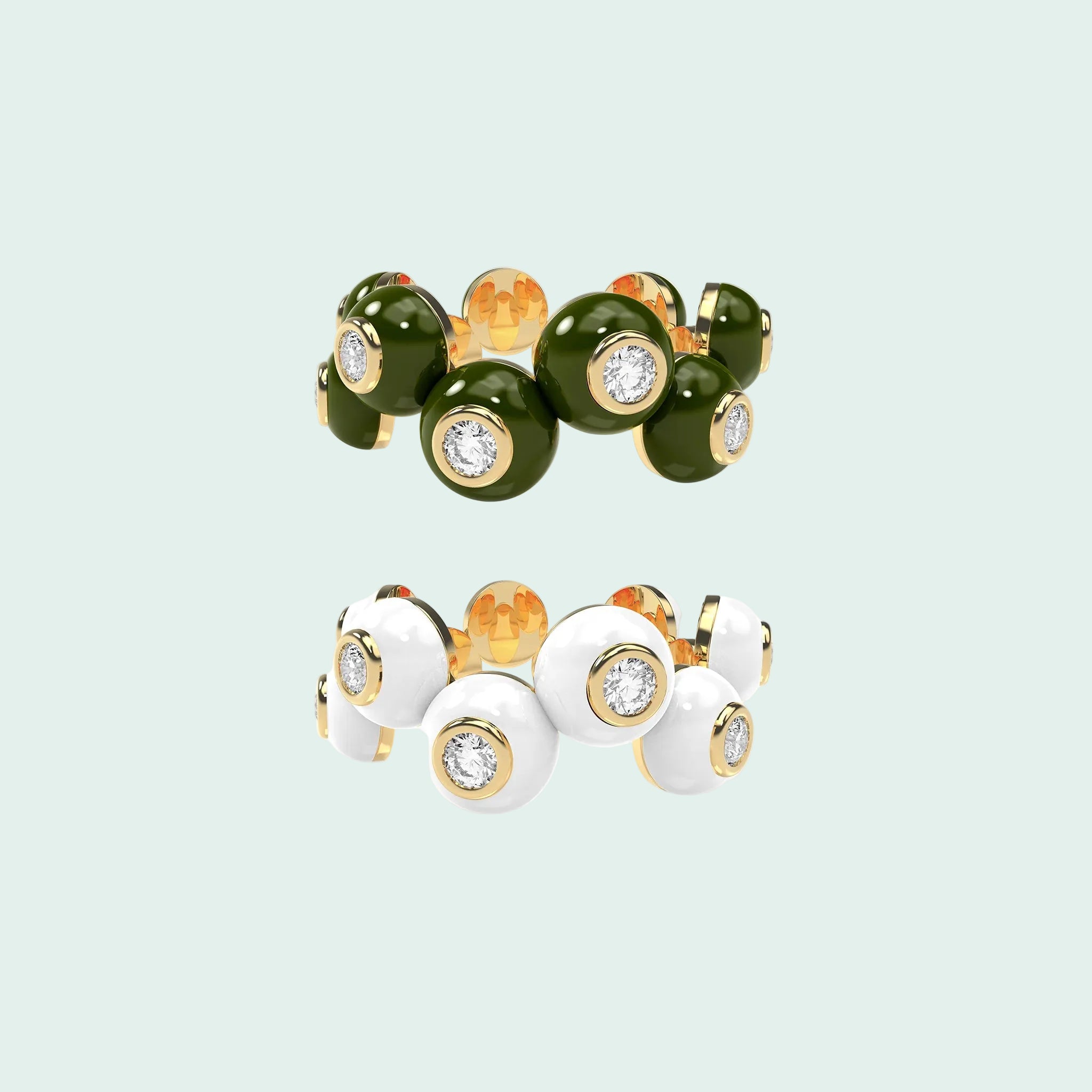 Two rings with green, white, and gold colors on a white background