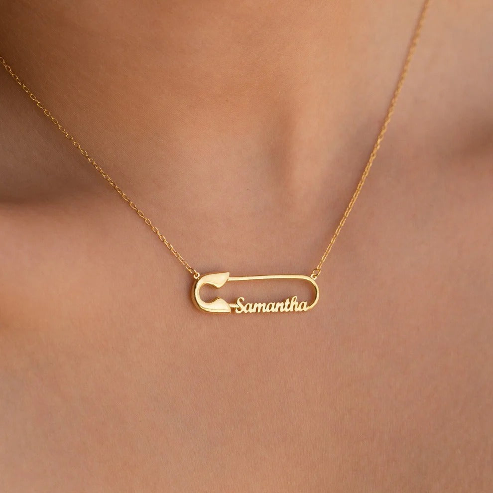 Gold necklace with a 'Samantha' pendant on a blurred background
