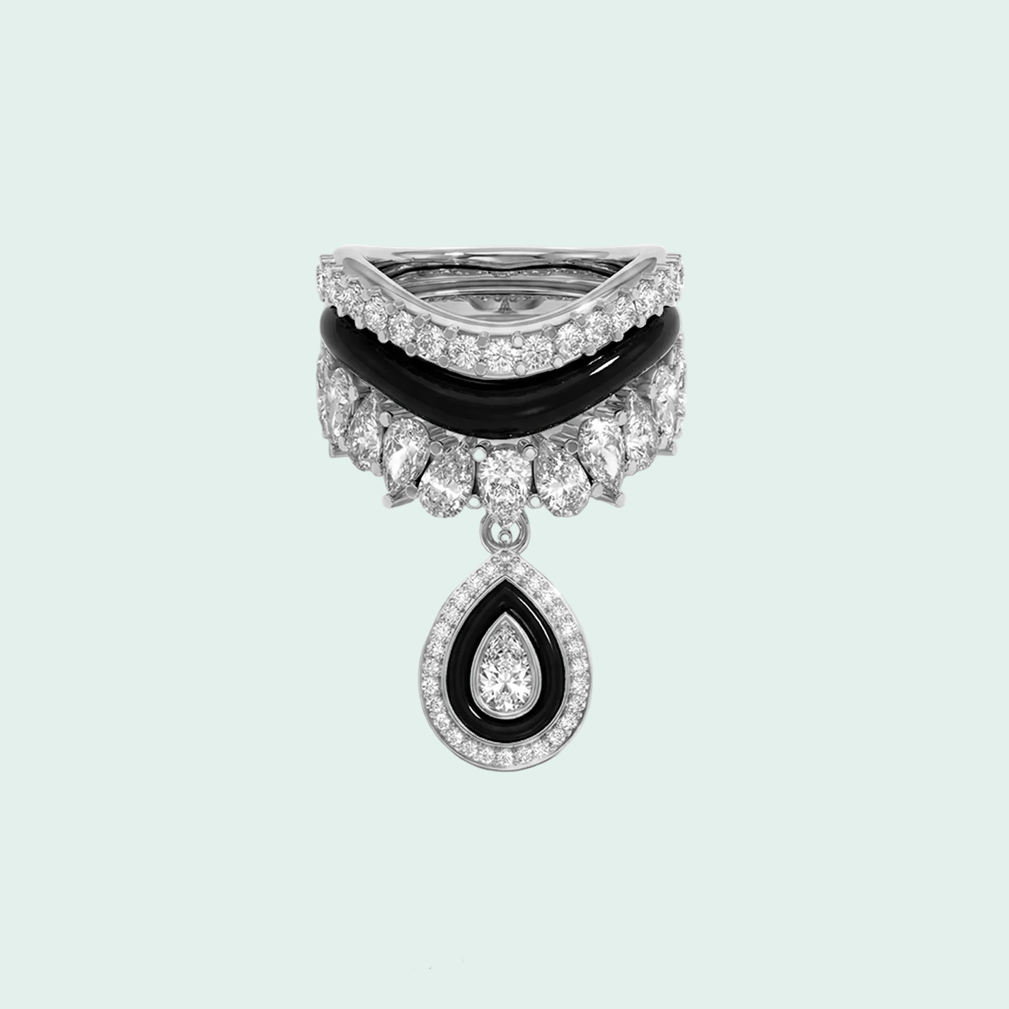 Stack of three diamond and black stone rings on a white background
