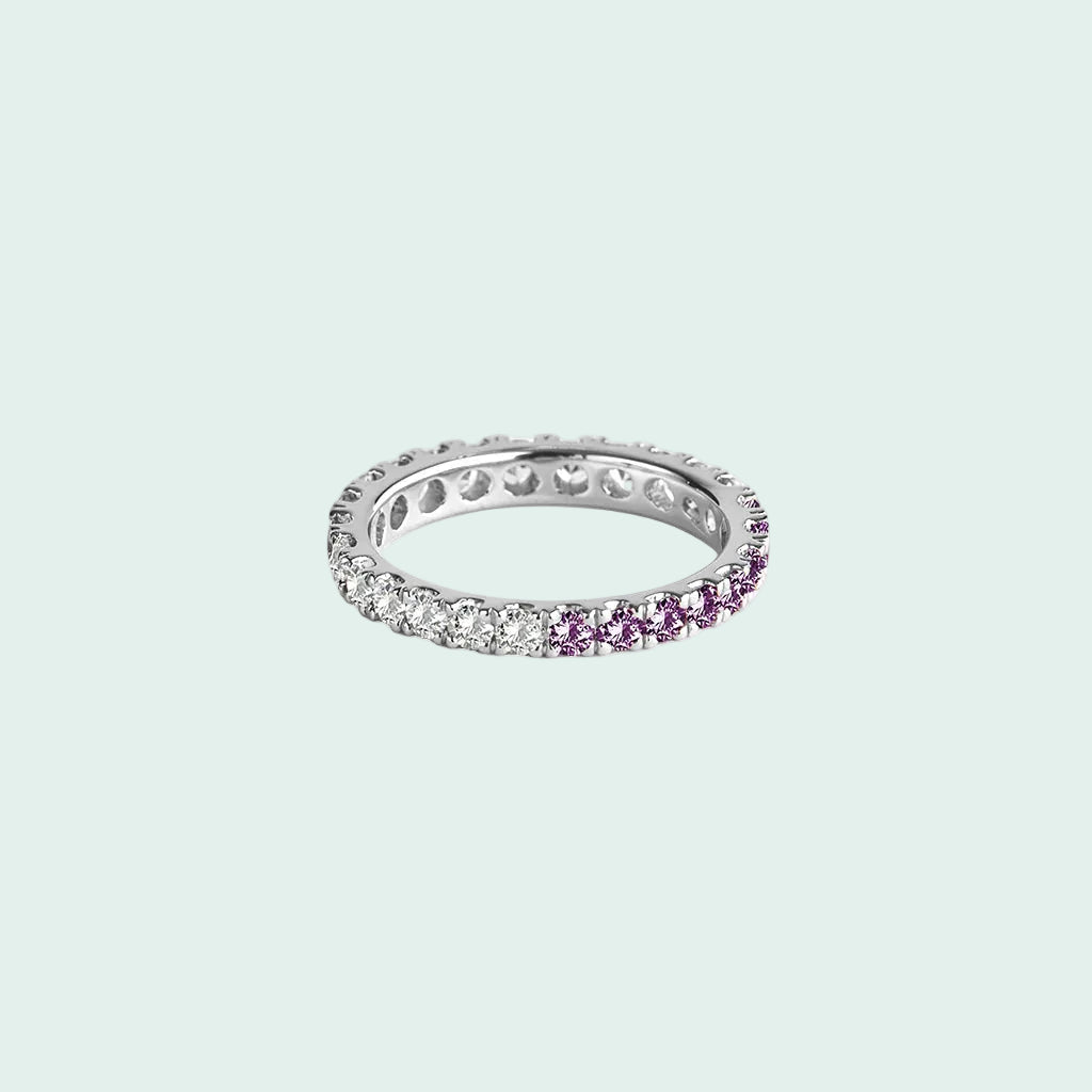 Silver ring with purple gemstones on a white background