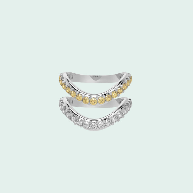 Two diamond rings, one with yellow gemstones and the other with white gemstones, on a white background.