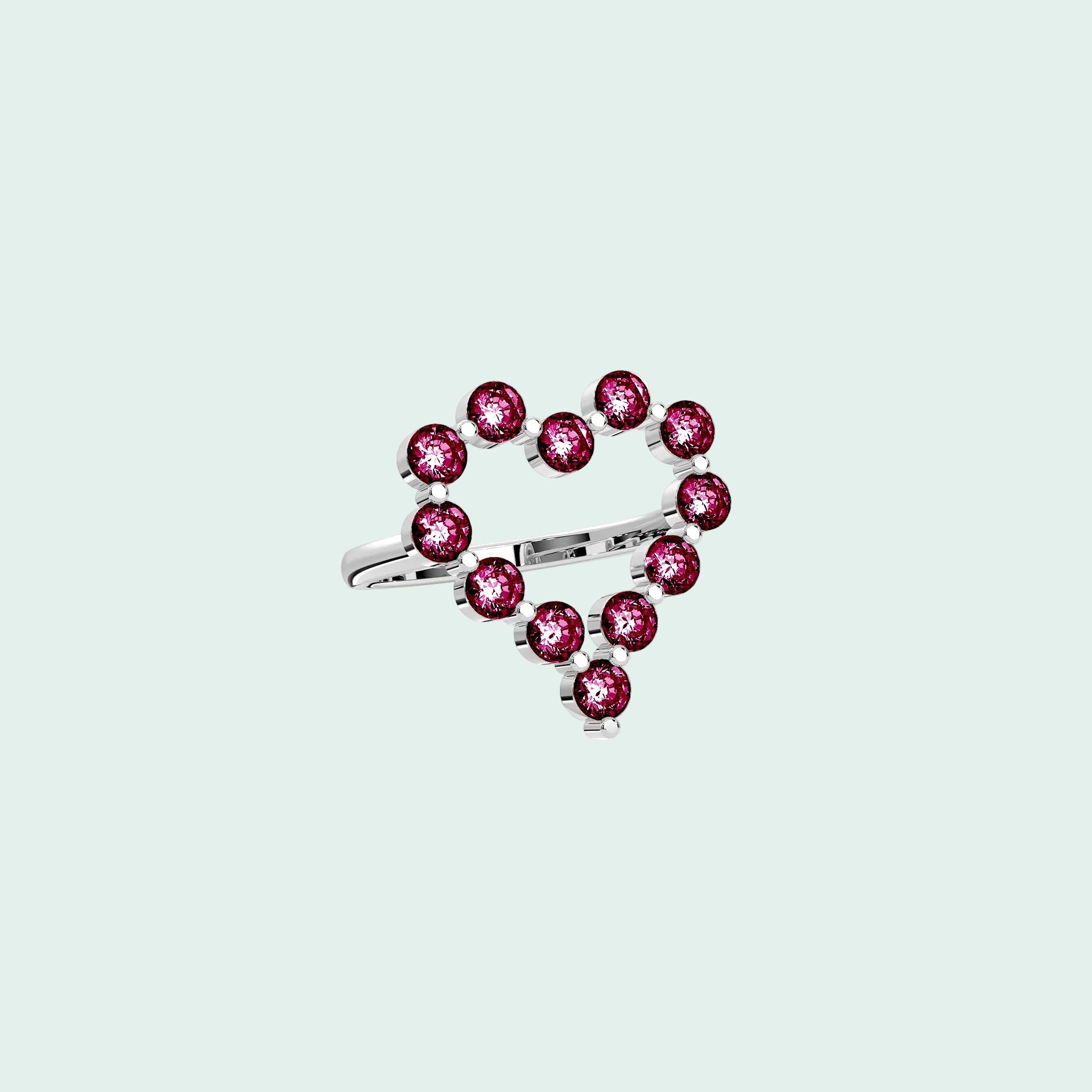 Heart-shaped ring with pink gemstones on a white background