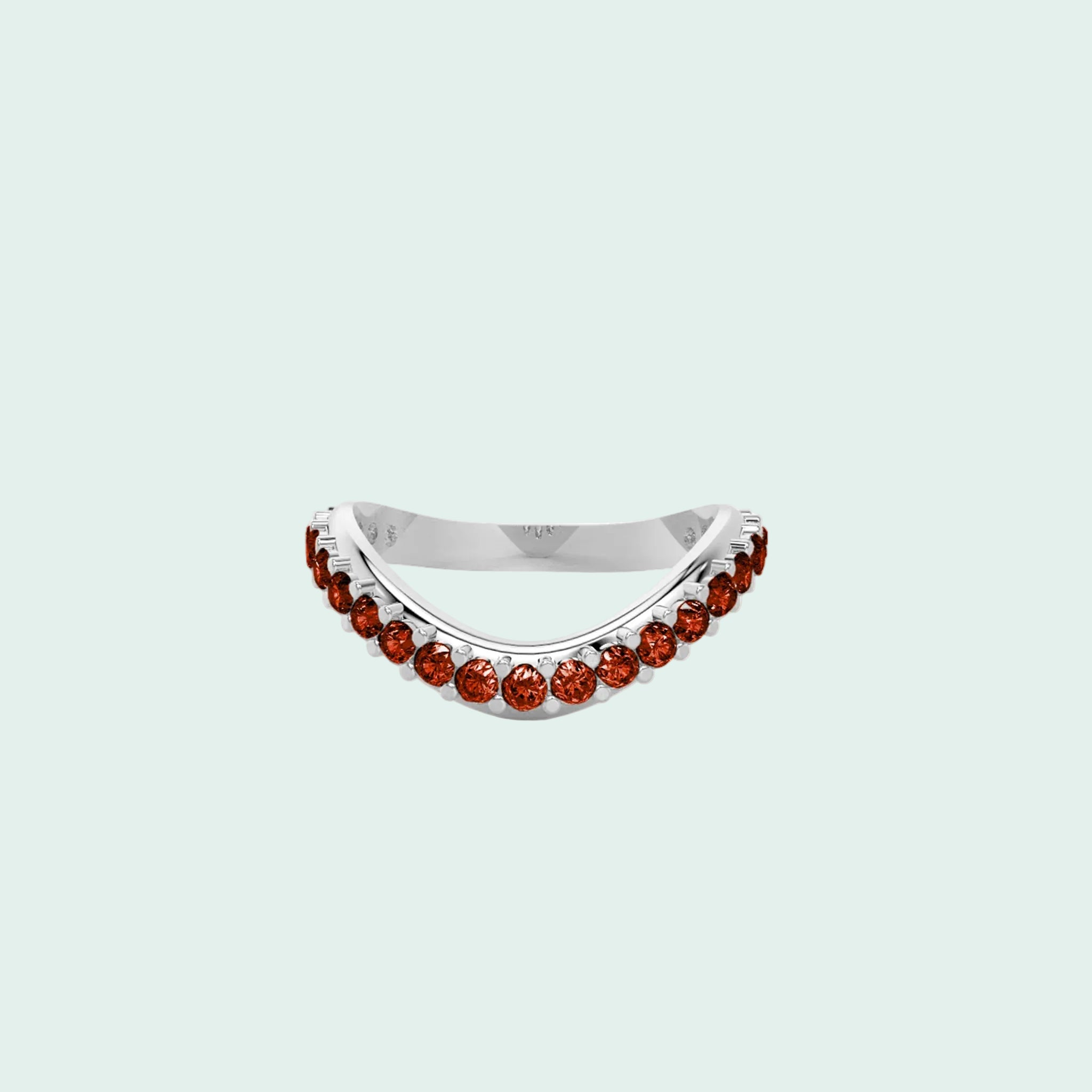 Silver ring with red gemstones on a white background